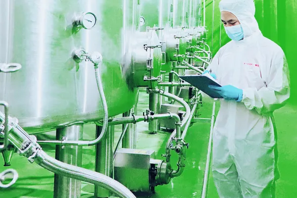 Lab technician performing multi-stage quality control testing for peptide production