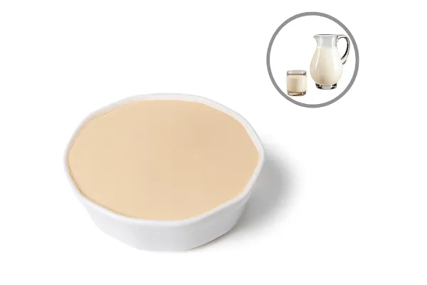 Bowl of whey protein peptide powder with milk pitcher and glass representing its dairy source