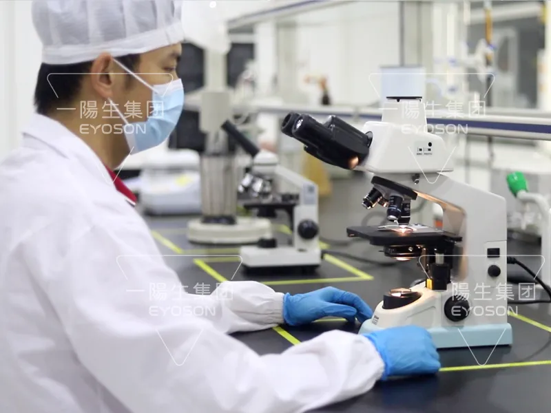 Technician operating advanced laboratory instruments at EYOSON lab.