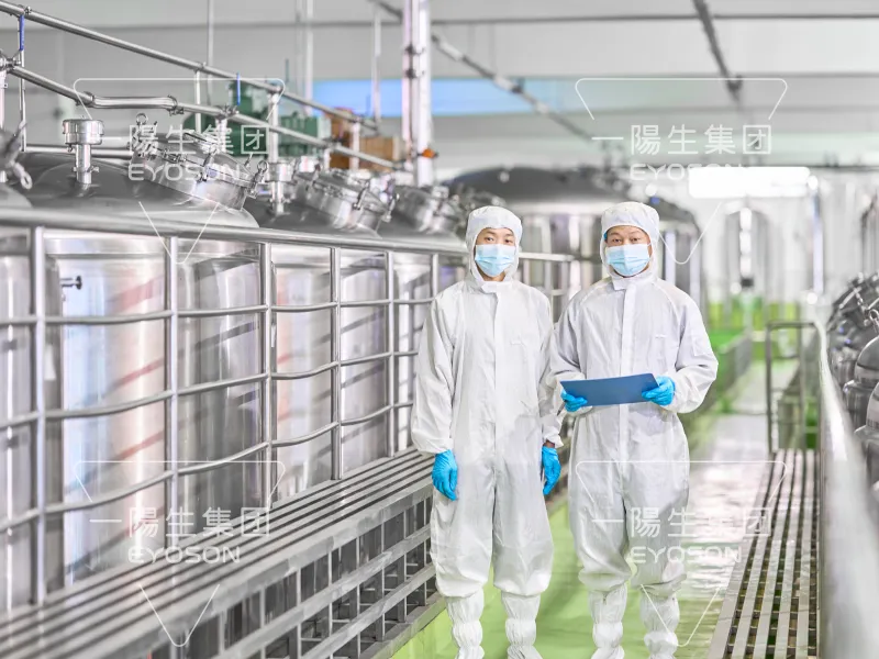 Scientist working inside the fermentation workshop, monitoring production processes in a clean facility.